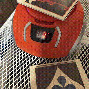 a CD player with two Grizzly Bear CDs