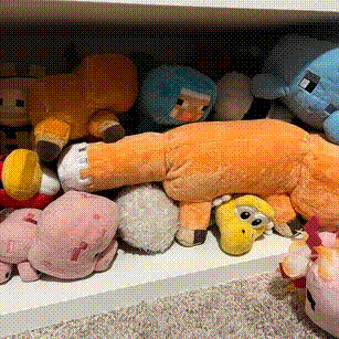 a collection of plushies under a desk